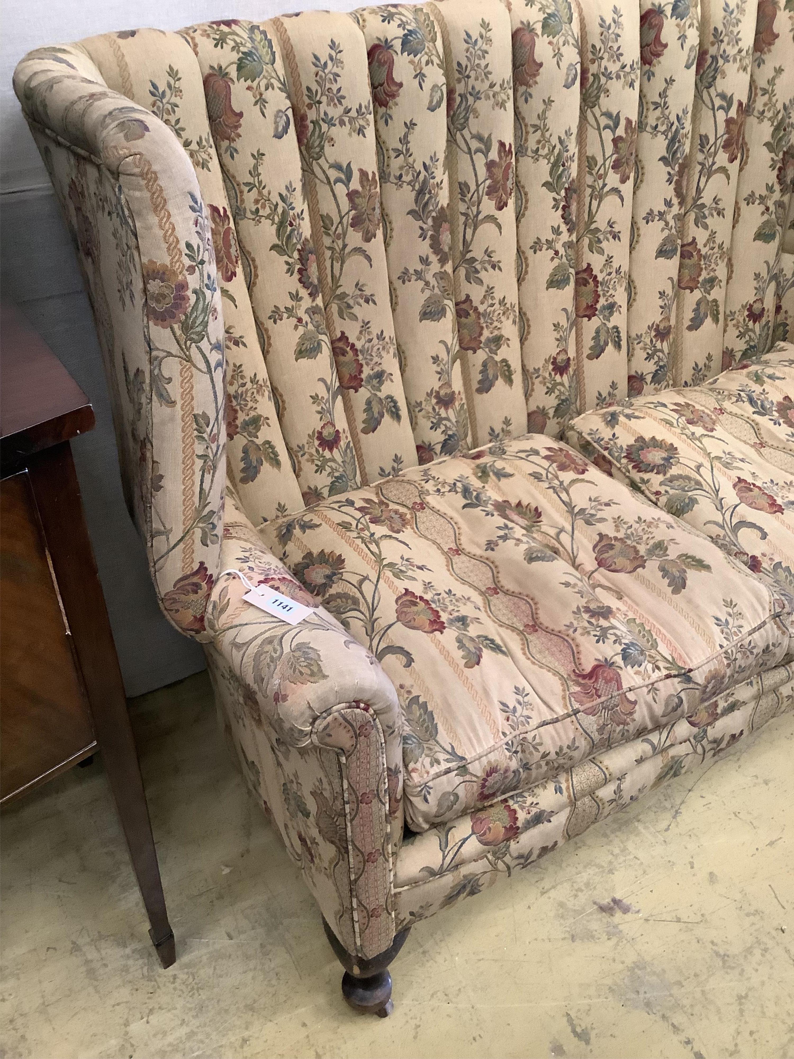 A barrel back upholstered 1920's two seat sofa, length 140cm, depth 70cm, height 110cm